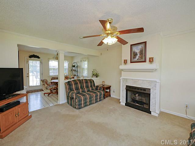 9922 Mini Ranch Road Waxhaw, NC 28173 - Photo 8 of 16 a living room with furniture a fireplace and a flat screen tv