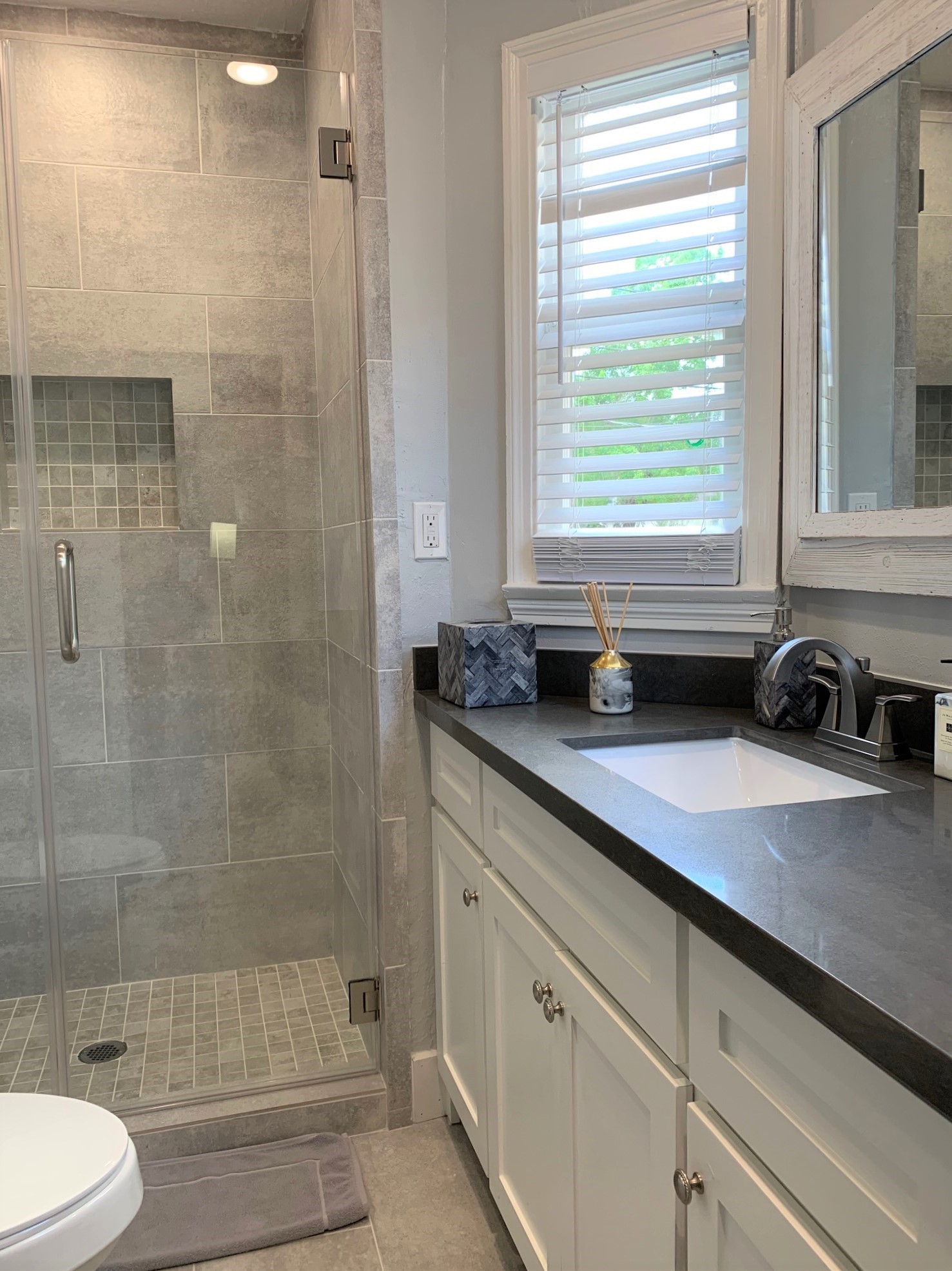 3909 Rice Boulevard Houston, TX 77005 - Photo 14 of 17 a bathroom with a granite countertop sink a toilet and shower