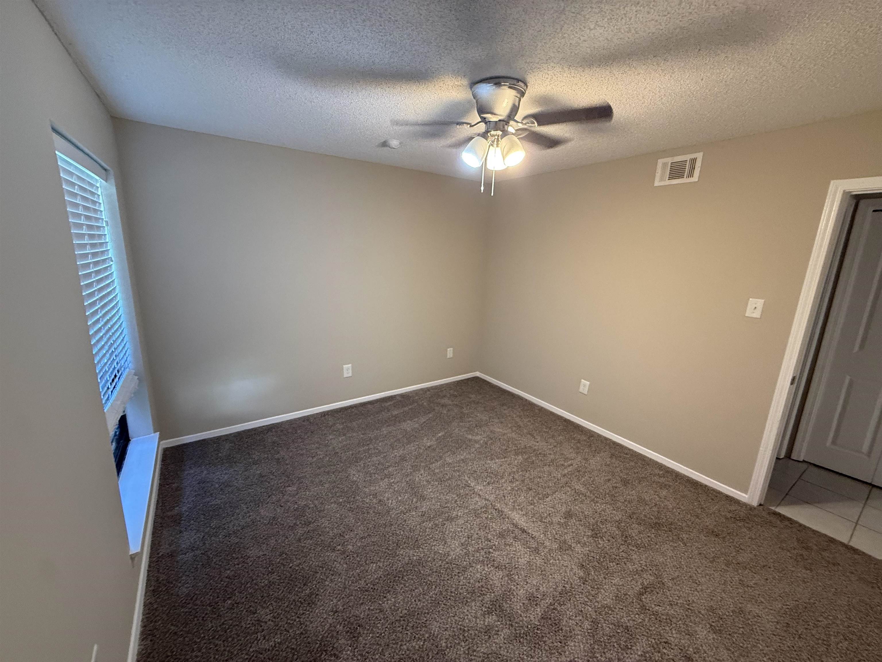 3084 Rising Sun Road, Unit 68 Lakeland, TN 38002 - Photo 6 of 13 Neutral wall colors, carpet flooring, a ceiling fan with integrated lighting, and a window with blinds