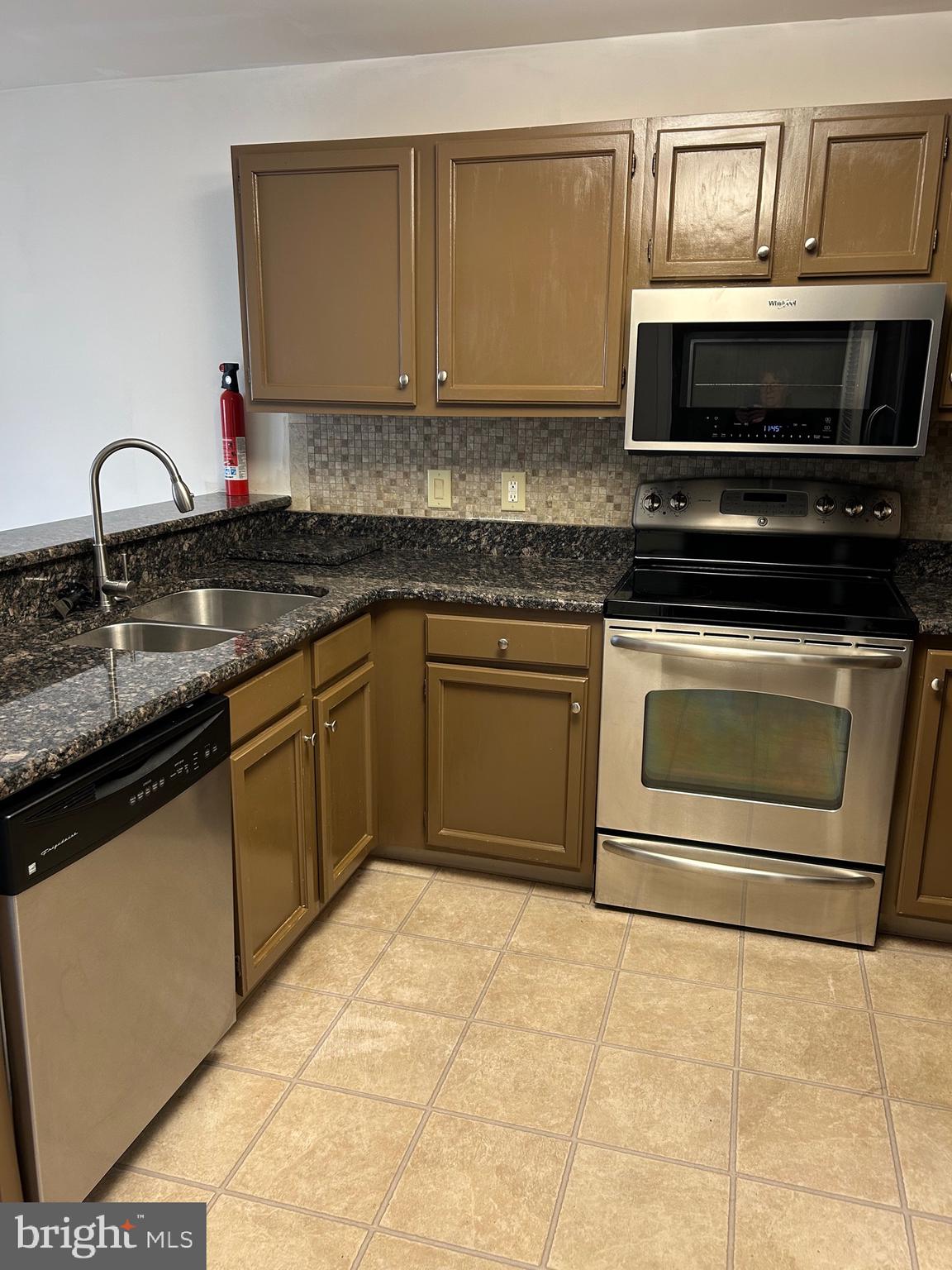 1201 Independence Way Newark, DE 19713 - Photo 10 of 24 a kitchen with stainless steel appliances granite countertop a stove a sink and a microwave