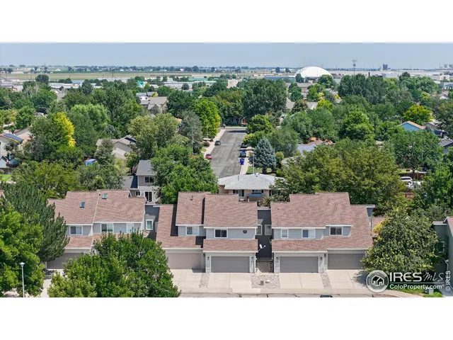 an aerial view of a house with a yard basket ball court and outdoor seating