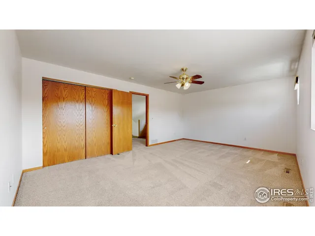 a living room with furniture and a ceiling fan