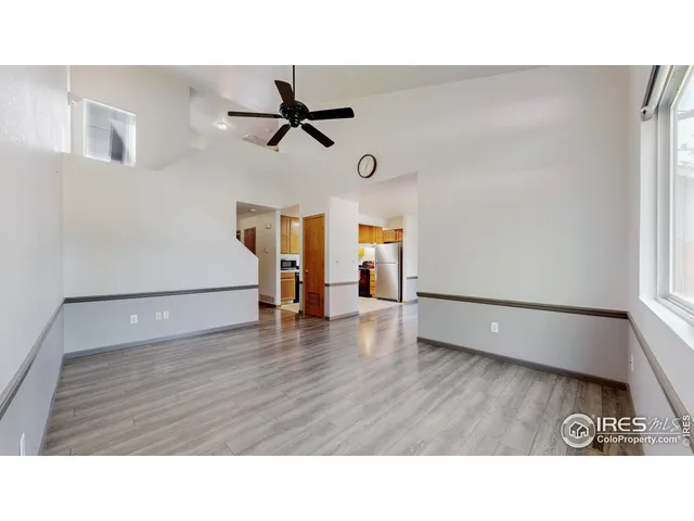 a room with wooden floor and windows