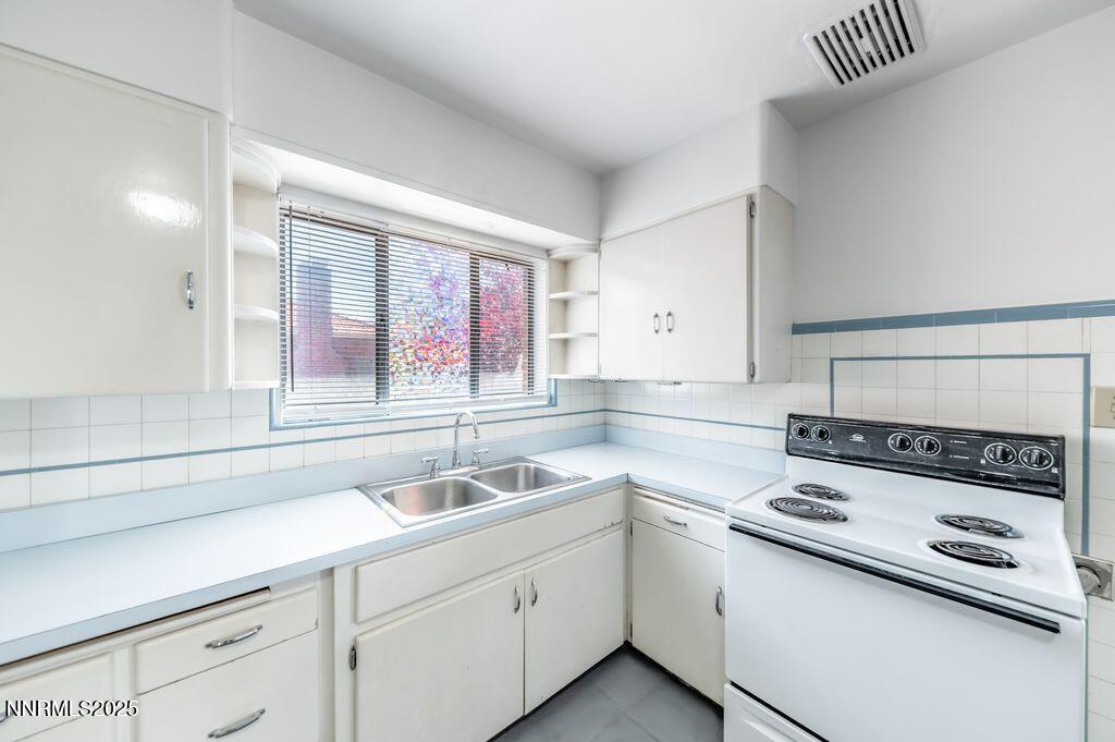 680 Edelweiss Street Reno, NV 89502 - Photo 13 of 29 a kitchen with a sink stove and cabinets