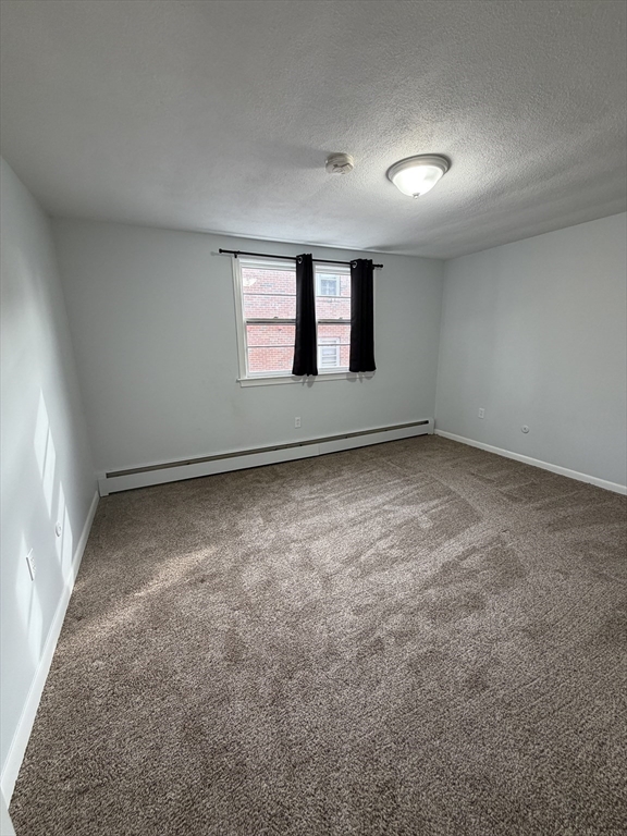 85 Trapelo Road, Unit 41 Waltham, MA 02452 - Photo 3 of 15 an empty room with windows