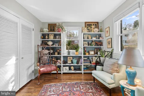 a living room with furniture and a book shelf