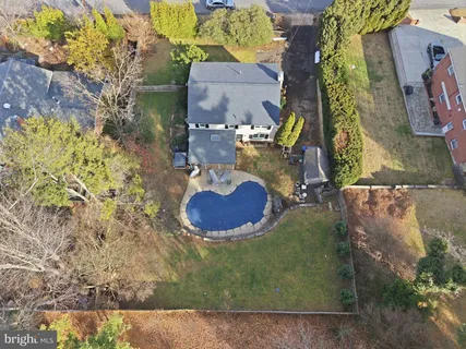 an aerial view of a house with yard swimming pool and outdoor seating