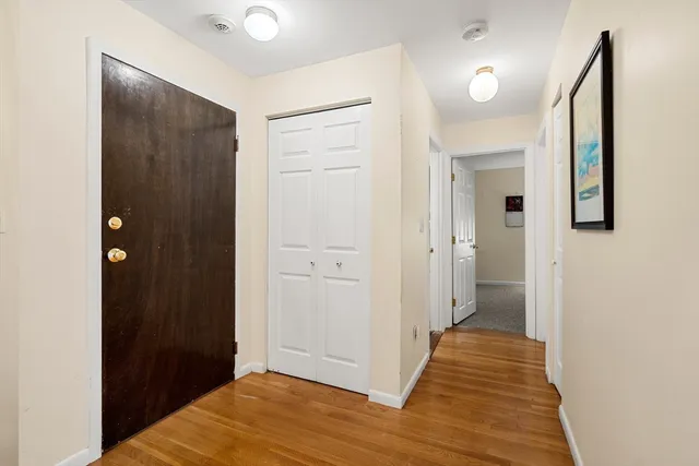 a view of a hallway with wooden floor