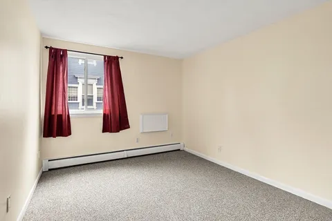 a view of a livingroom with wooden floor and window