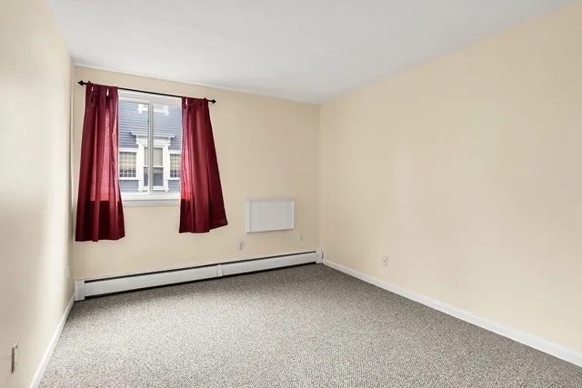 a view of a livingroom with wooden floor and window