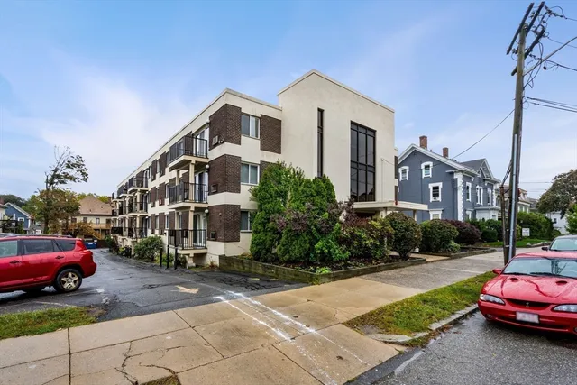 a car parked in front of a white house
