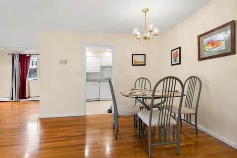 a view of a dining room with furniture wooden floor and chandelier