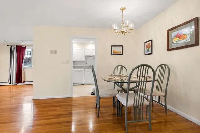 a view of a dining room with furniture wooden floor and chandelier