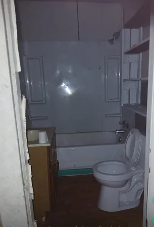 a white toilet sitting next to a bathroom sink