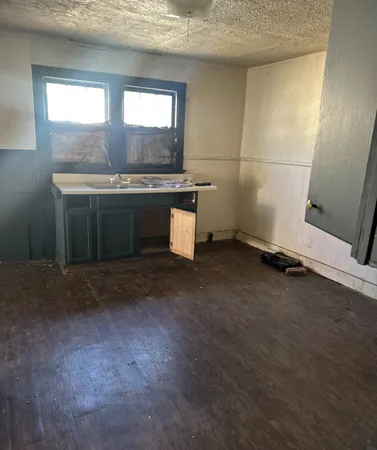 a kitchen with a sink and a stove top oven