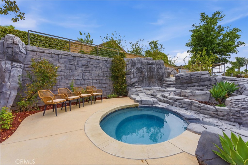 29131 Bouquet Canyon Road Silverado, CA 92676 - Photo 30 of 74 Rock spa and waterfall feature with stone landscaping with seating are