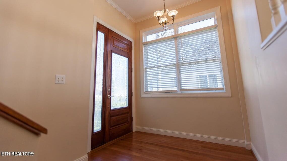 275 Hawthorn Loop Crossville, TN 38555 - Photo 14 of 59 an empty room with wooden floor and windows