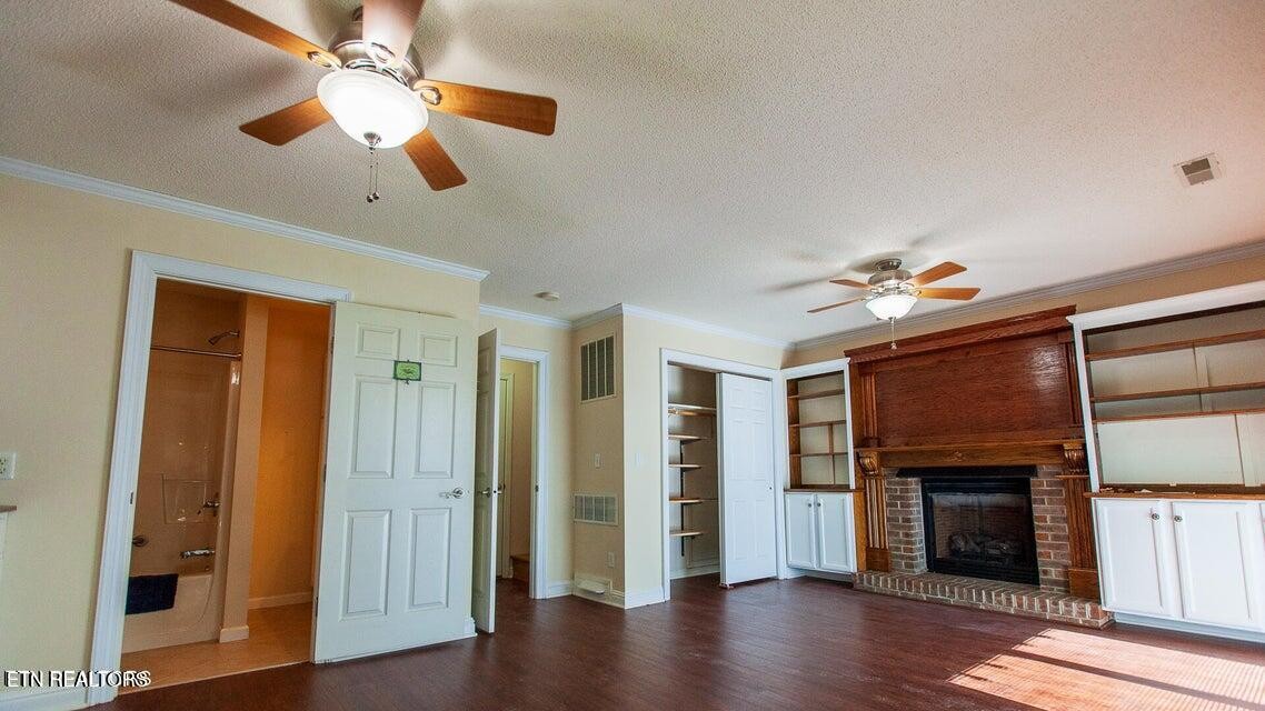 275 Hawthorn Loop Crossville, TN 38555 - Photo 18 of 59 a view of a livingroom with a ceiling fan wooden floor and a ceiling fan
