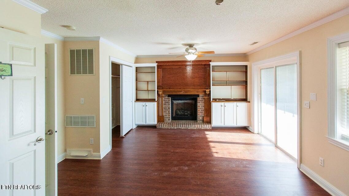 275 Hawthorn Loop Crossville, TN 38555 - Photo 20 of 59 a view of a hallway with wooden floor and a fireplace