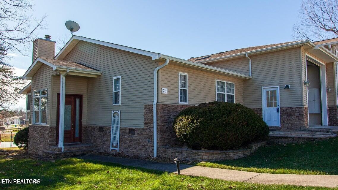 275 Hawthorn Loop Crossville, TN 38555 - Photo 2 of 59 a view of a house that has a small yard and large trees