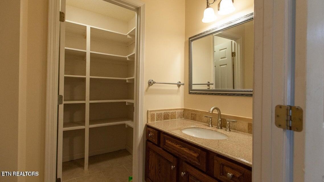 275 Hawthorn Loop Crossville, TN 38555 - Photo 32 of 59 a bathroom with a granite countertop sink and a mirror