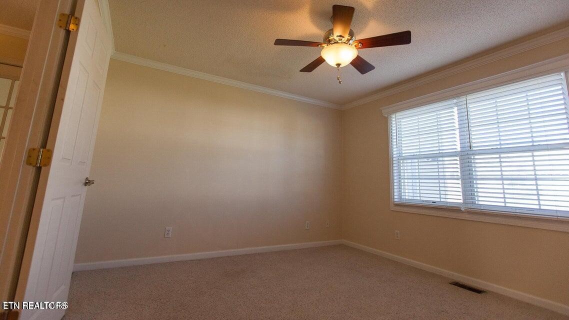 275 Hawthorn Loop Crossville, TN 38555 - Photo 34 of 59 an empty room with a window and a fan