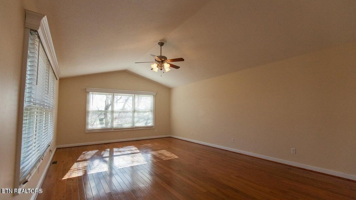 275 Hawthorn Loop Crossville, TN 38555 - Photo 46 of 59 an empty room with wooden floor chandelier and windows
