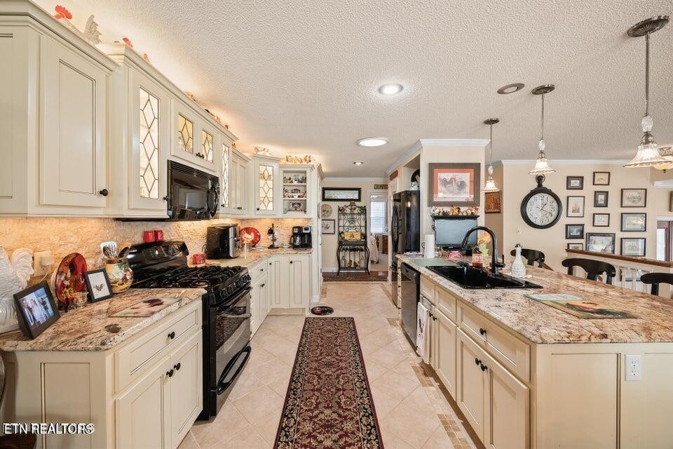 275 Hawthorn Loop Crossville, TN 38555 - Photo 52 of 59 a kitchen with stainless steel appliances granite countertop a stove and a sink