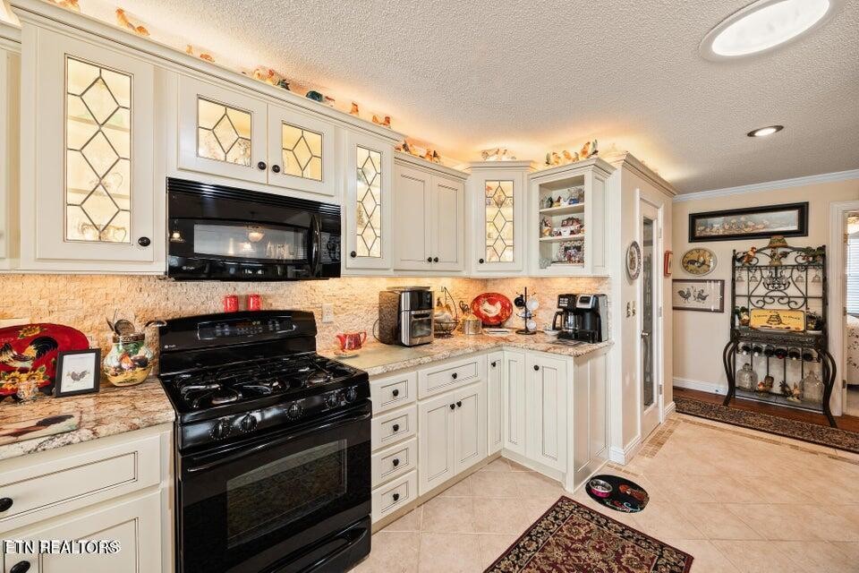 275 Hawthorn Loop Crossville, TN 38555 - Photo 54 of 59 a kitchen with stainless steel appliances white cabinets a stove top oven a sink and dishwasher