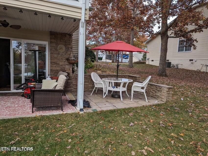 275 Hawthorn Loop Crossville, TN 38555 - Photo 56 of 59 a view of a patio with a table and chairs under an umbrella