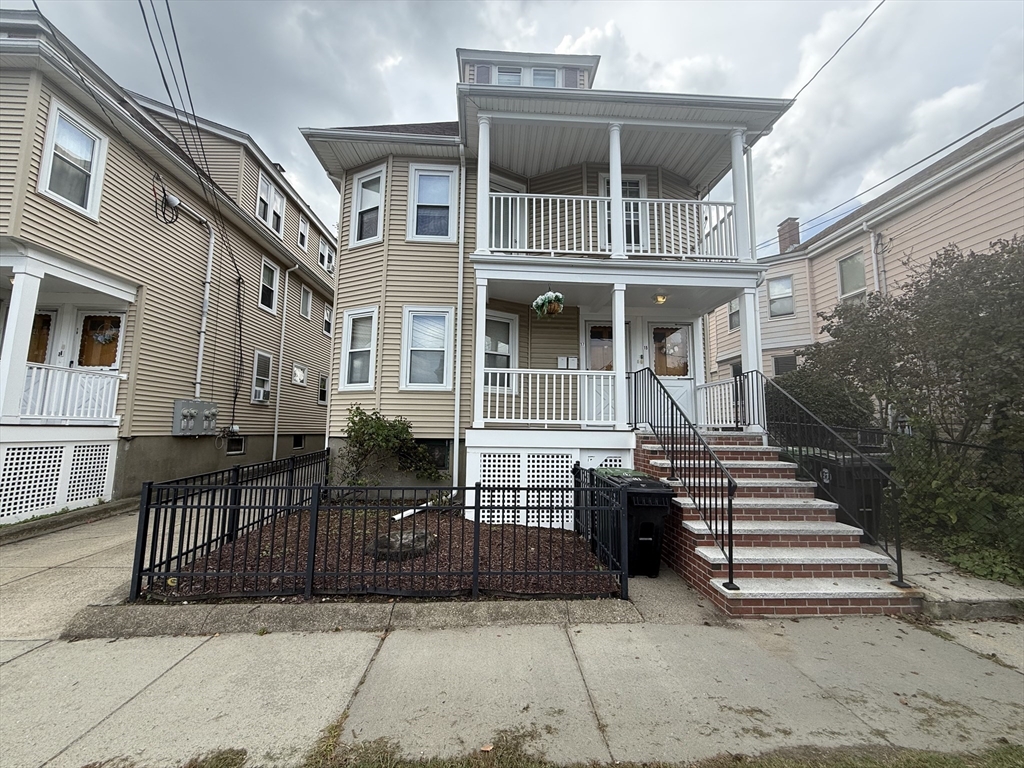 a front view of a house with stairs