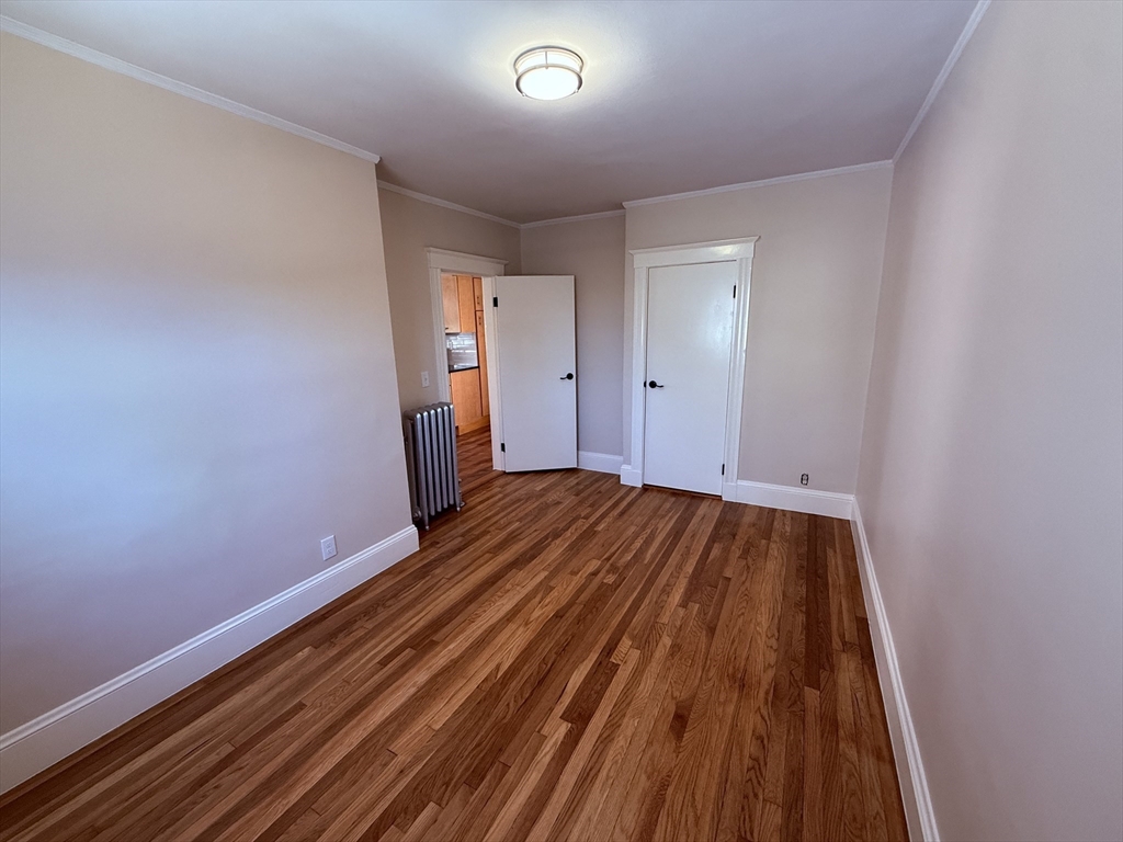 15 Chauncey Street, Unit 2 Watertown, MA 02472 - Photo 11 of 16 a view of a room with wooden floor and staircase