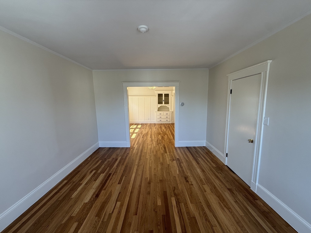 15 Chauncey Street, Unit 2 Watertown, MA 02472 - Photo 3 of 16 a view of wooden floor in an empty room