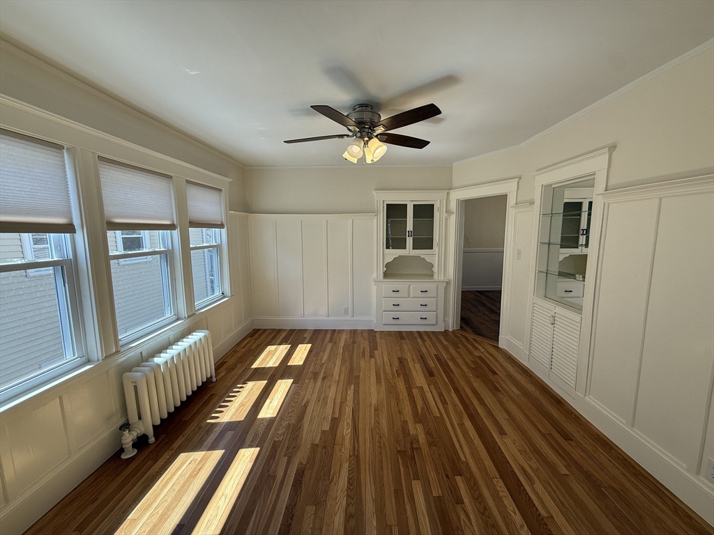 15 Chauncey Street, Unit 2 Watertown, MA 02472 - Photo 4 of 16 a view of an empty room with a fireplace and a window