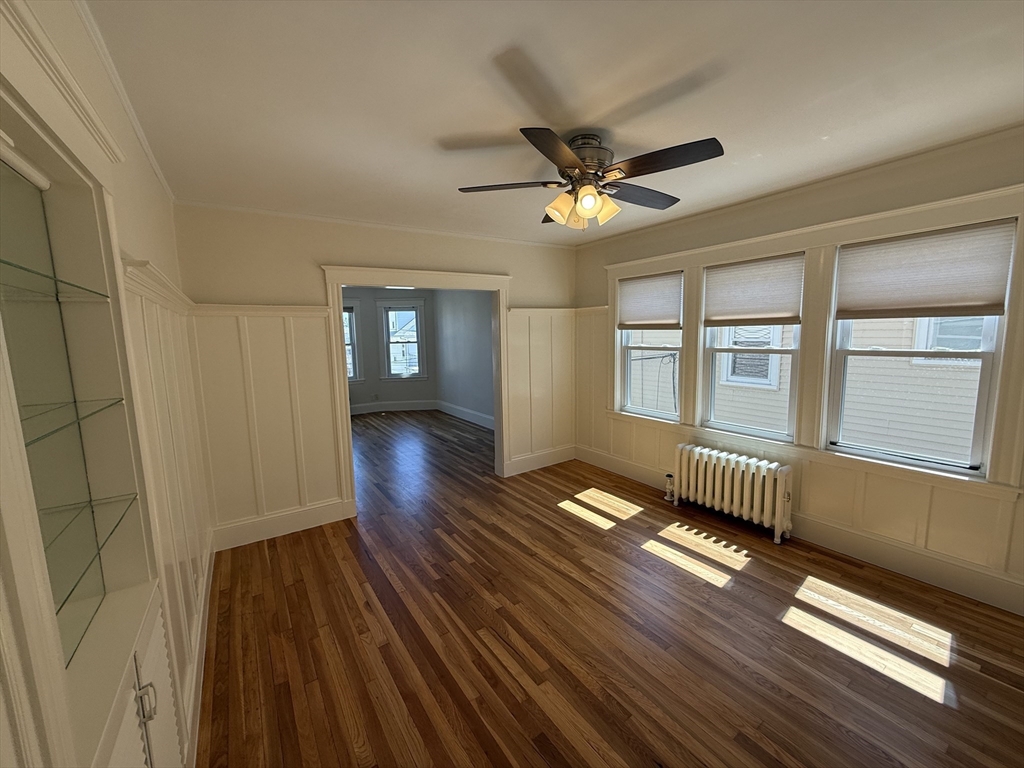 15 Chauncey Street, Unit 2 Watertown, MA 02472 - Photo 5 of 16 a view of empty room with wooden floor and fan