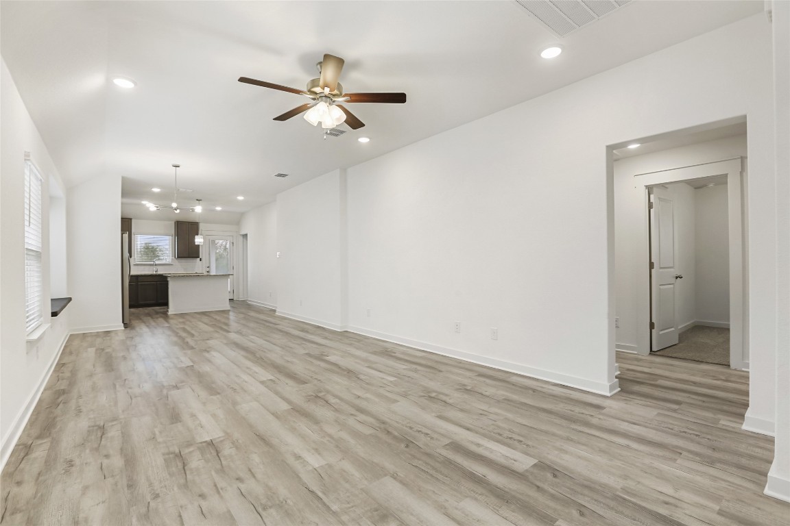 2340 Sawdust Drive Georgetown, TX 78633 - Photo 11 of 40 wooden floor in an empty room with a kitchen