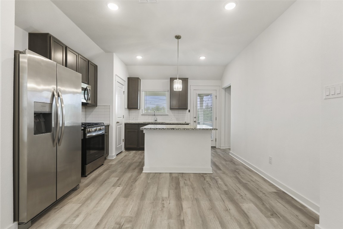 2340 Sawdust Drive Georgetown, TX 78633 - Photo 14 of 40 a large kitchen with a refrigerator and a stove top oven