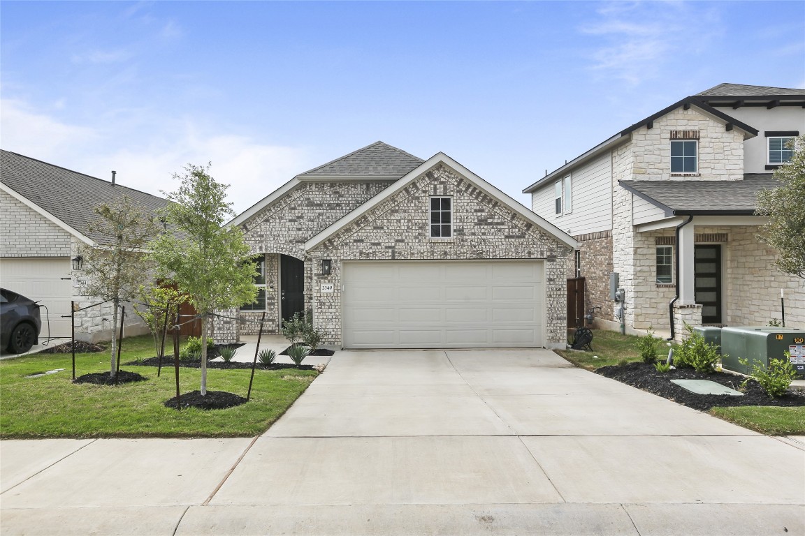 2340 Sawdust Drive Georgetown, TX 78633 - Photo 2 of 40 a front view of a house with a yard and potted plants