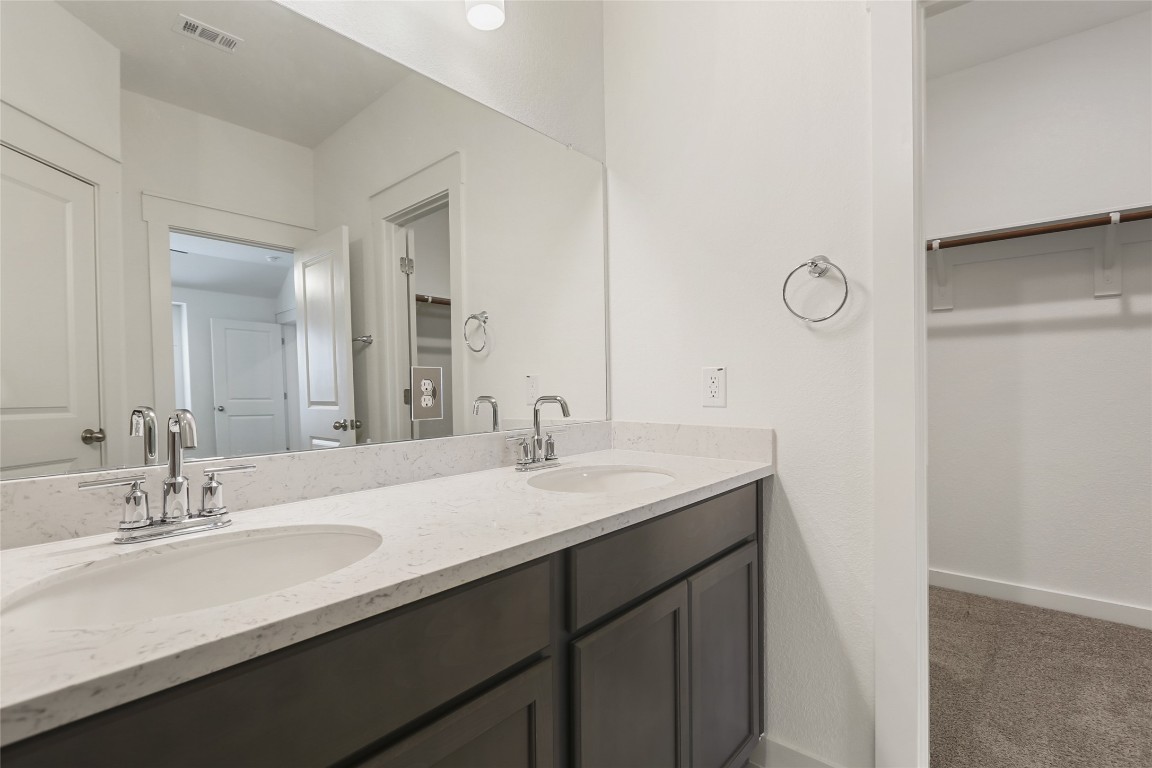 2340 Sawdust Drive Georgetown, TX 78633 - Photo 21 of 40 a bathroom with a sink and a mirror