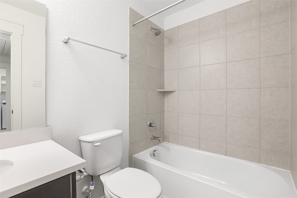 2340 Sawdust Drive Georgetown, TX 78633 - Photo 24 of 40 a white toilet sitting next to a bath tub