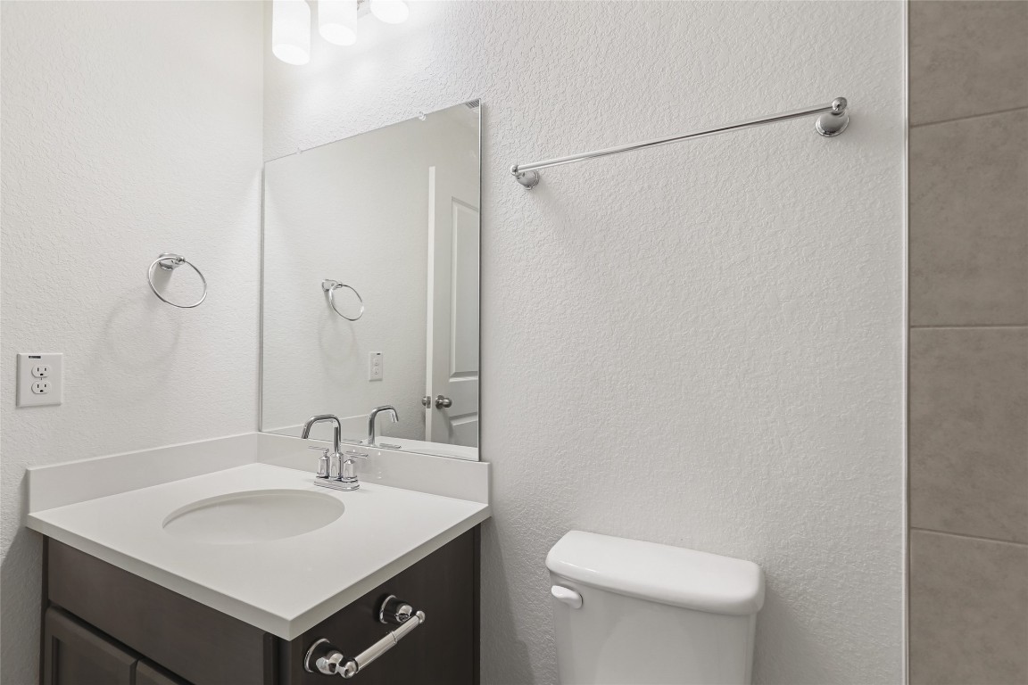2340 Sawdust Drive Georgetown, TX 78633 - Photo 25 of 40 a bathroom with a sink toilet and mirror
