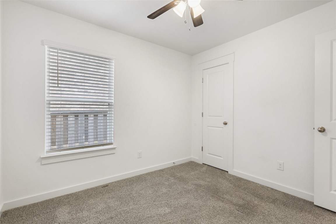 2340 Sawdust Drive Georgetown, TX 78633 - Photo 30 of 40 an empty room with a window and ceiling fan