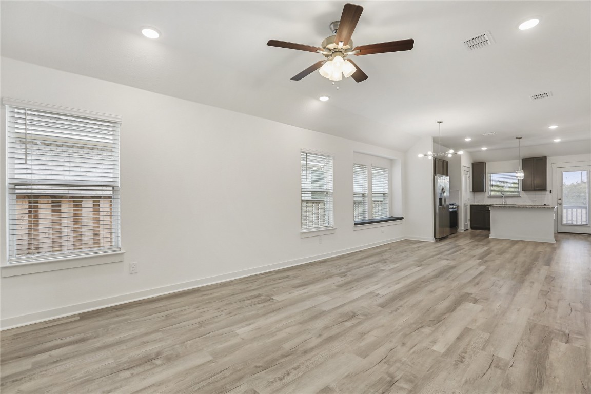2340 Sawdust Drive Georgetown, TX 78633 - Photo 3 of 40 a view of an empty room with a window and wooden floor