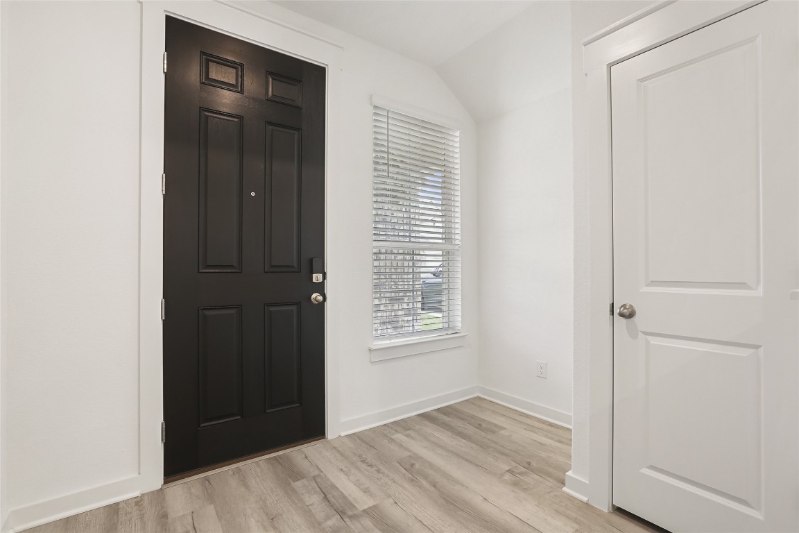 2340 Sawdust Drive Georgetown, TX 78633 - Photo 5 of 40 a view of an empty room with wooden floor and a window