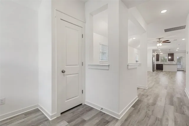 a view of a hallway with wooden floor