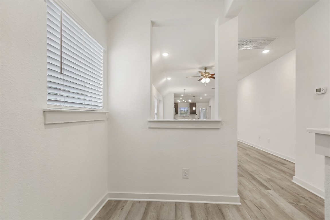 2340 Sawdust Drive Georgetown, TX 78633 - Photo 7 of 40 an empty room with wooden floor and windows