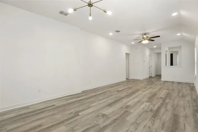an empty room with fan and a ceiling fan
