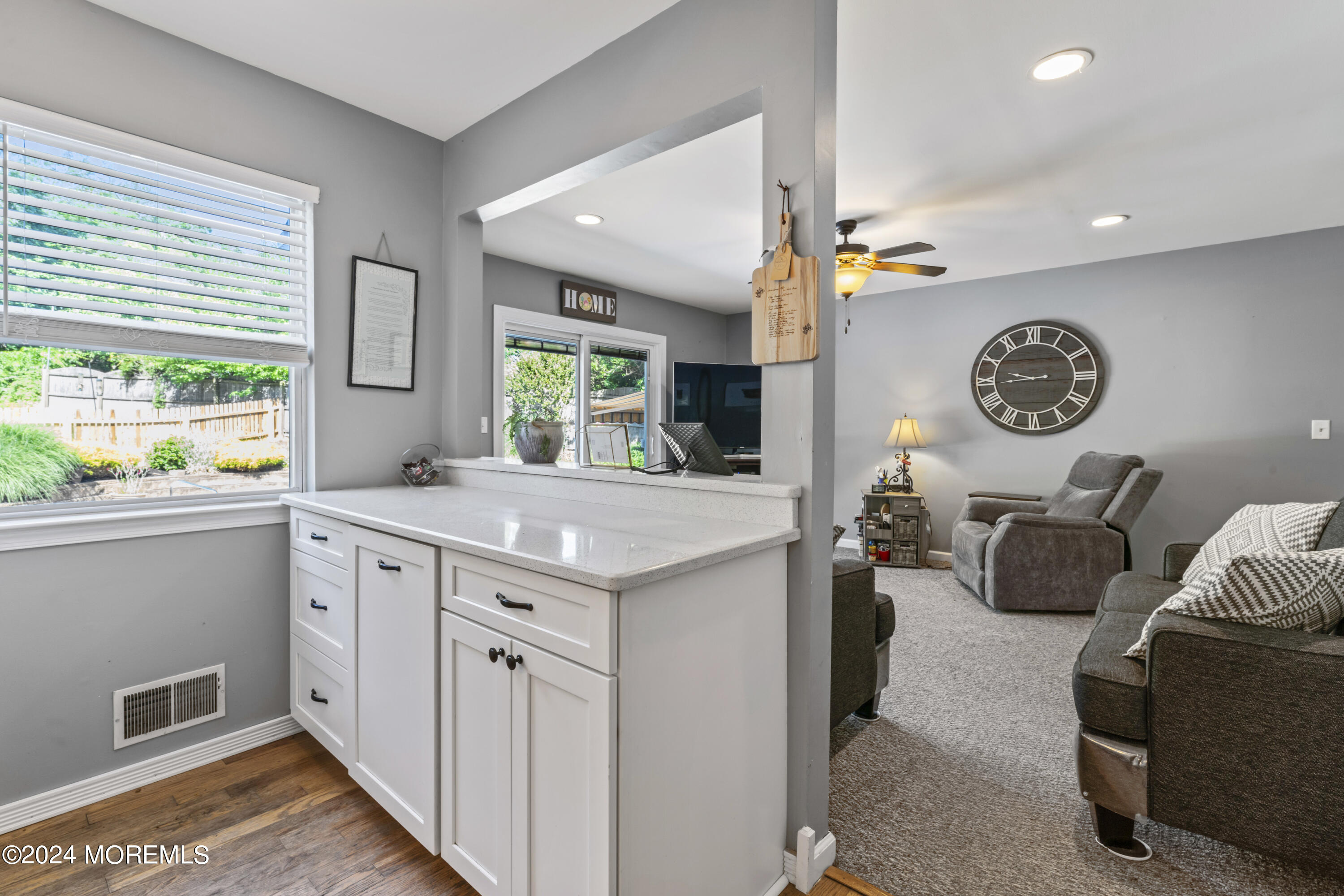 58 Lorelei Drive Howell, NJ 07731 - Photo 14 of 37 a hall with kitchen island granite countertop a sink and a large window