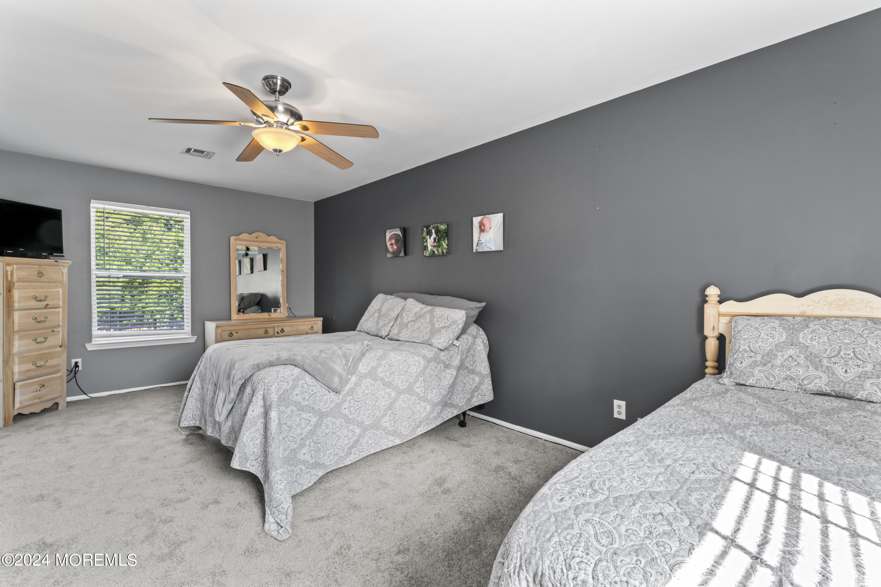 58 Lorelei Drive Howell, NJ 07731 - Photo 19 of 37 a bedroom with a bed and a chandelier