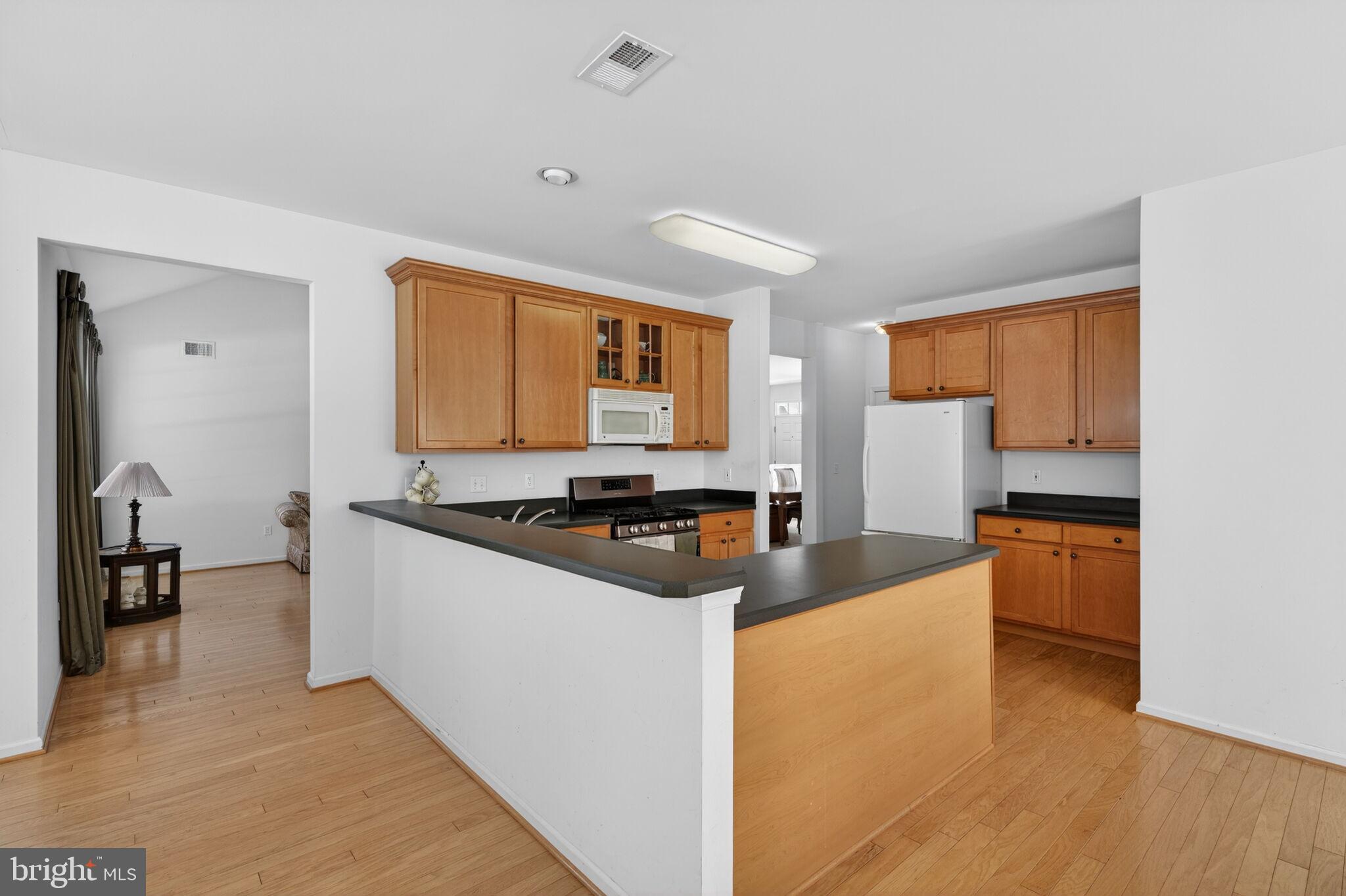 76 Portland Street Barnegat, NJ 08005 - Photo 20 of 47 a kitchen with stainless steel appliances granite countertop a stove a sink and a refrigerator